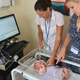 Fiona Moultrie and Gabriela Schmidt Mellado, who contributed to the new study, monitor a baby for signs of discomfort. (Image: University of Oxford)